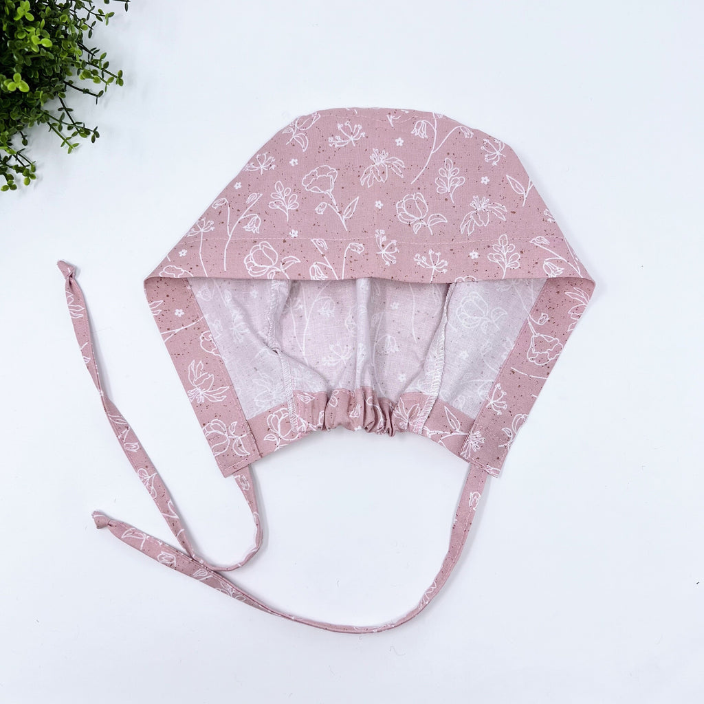 Pink and white Skull tie-back style surgical scrub cap for men by Paradise Caps.