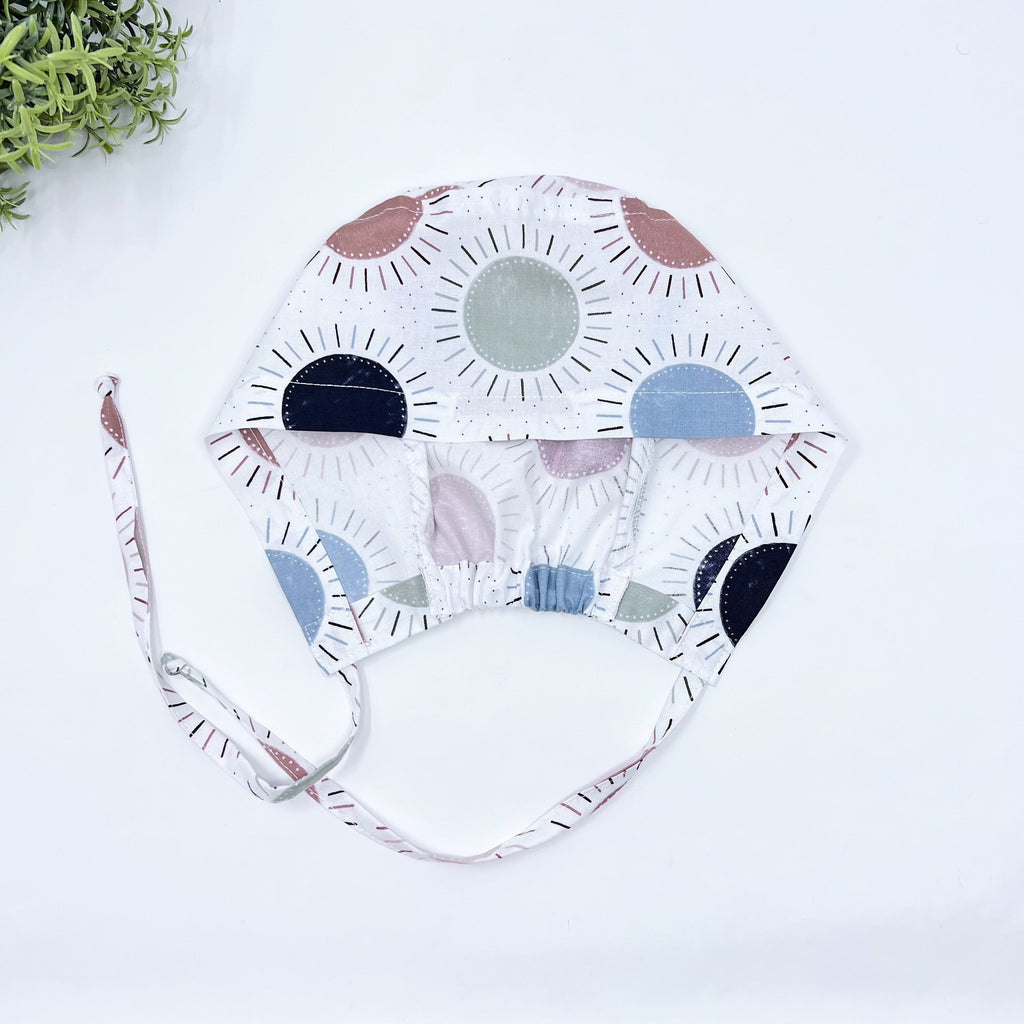 Navy & Coral Suns Skull tie-back style surgical scrub cap for men by Paradise Caps.