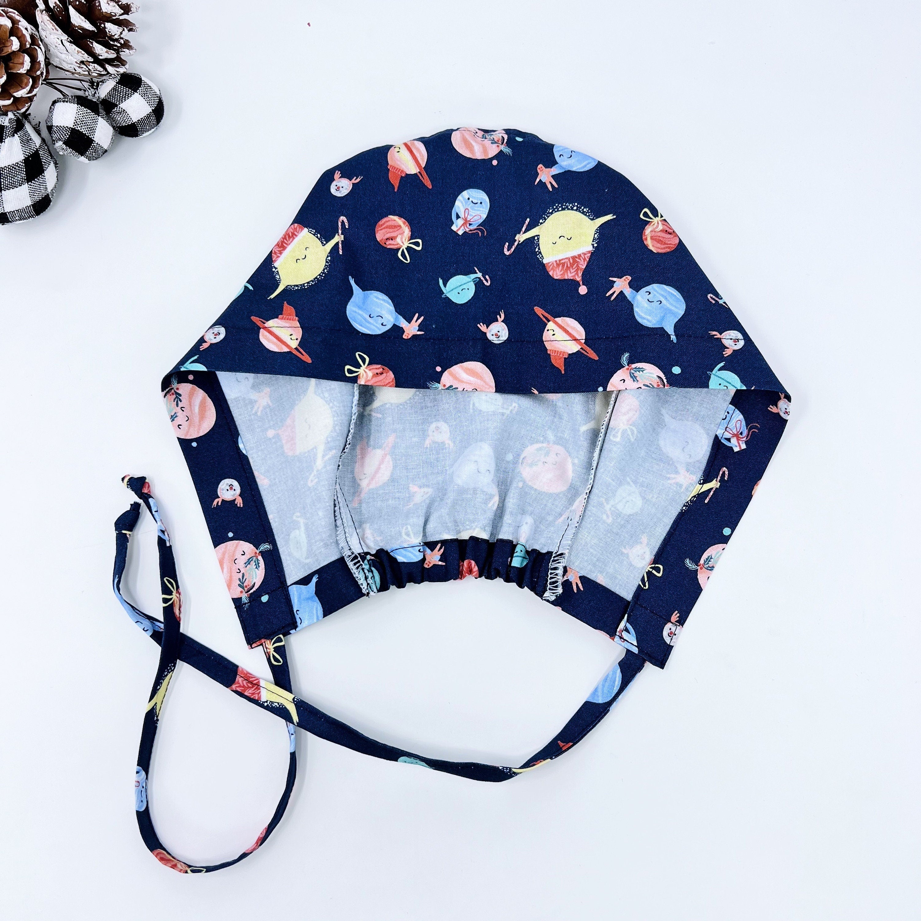 Holiday planet Skull tie-back style surgical scrub cap by Paradise Caps.