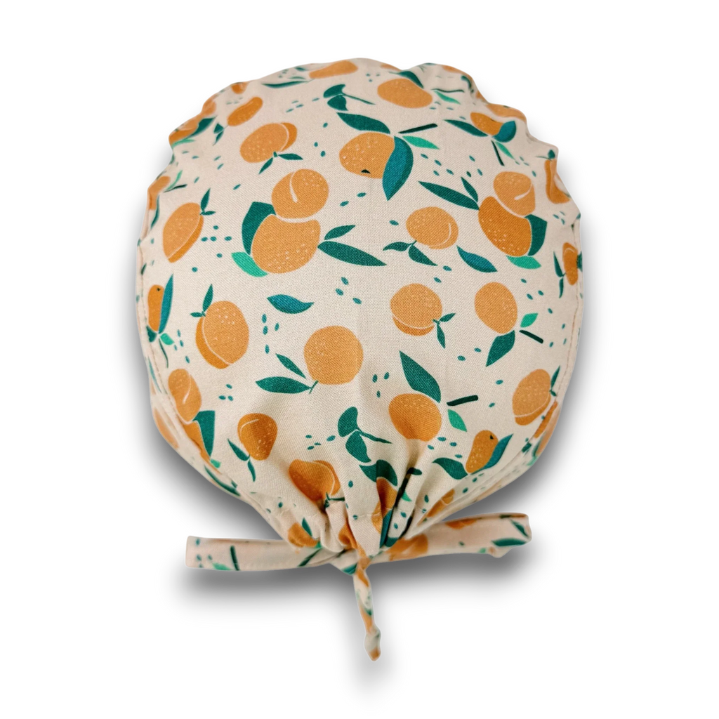Peach Skull tie-back style surgical scrub cap for men by Paradise Caps.